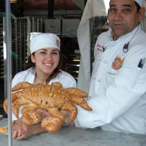 Bakers at Boudin Bakery show off their Crab shaped sourdough bread. Image Source: Wikimedia user BrokenSphere, February 18th 2008.