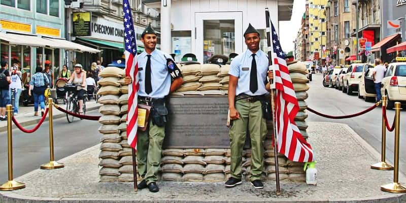 The actors who portray American soldiers at Checkpoint Charlie. Image Source: Pixabay user cocoparisienne under CC0 Creative Commons license.