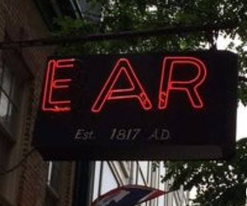 A neon sign that says Ear Est. 1817 AD that hangs above the Ear Inn in SoHo NYC