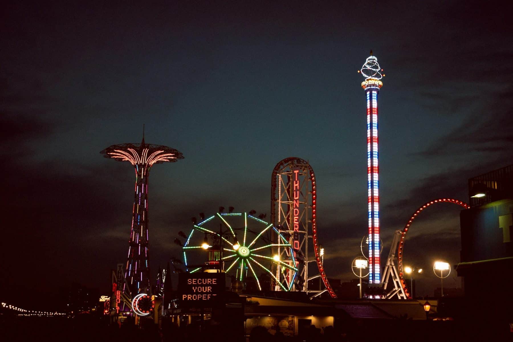 the rides at Luna Park in Coney Island lit up at night