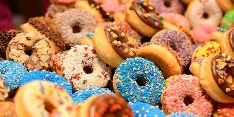 A pile of various donuts. Image source: Pixabay user AJEL. 