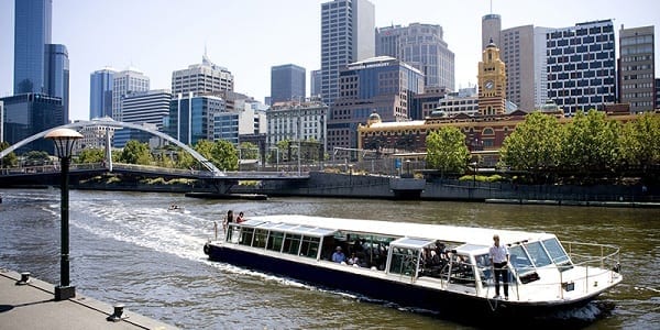 A Flat boat cruiser is seen cruising along the Yarra River in Melbourne
