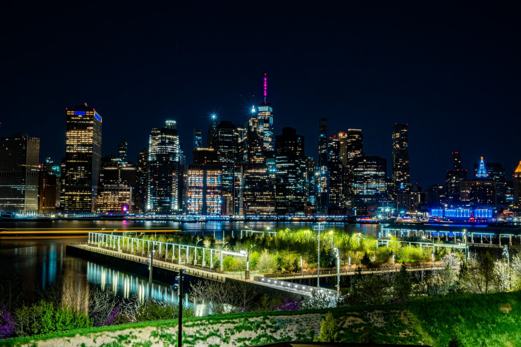 view at night of Lower Manhattan lit up from the brooklyn promenade