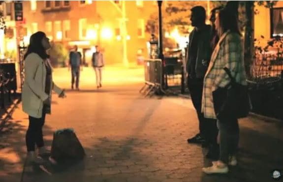 a tour guide telling two guests at night about the ghosts in Greenwich Village NYC