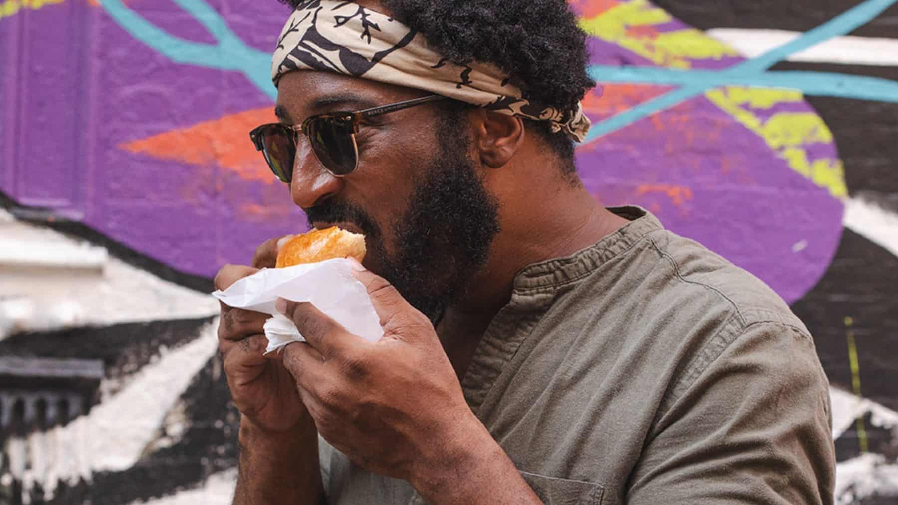 Tour guest enjoying food on a New York City food tour