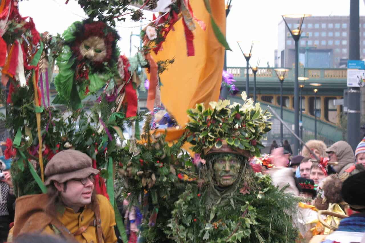 The arrival of the Holly Man by boat to Bankside on the River Thames, for the Lions' Part Theatre Company's Twelfth Night celebrations