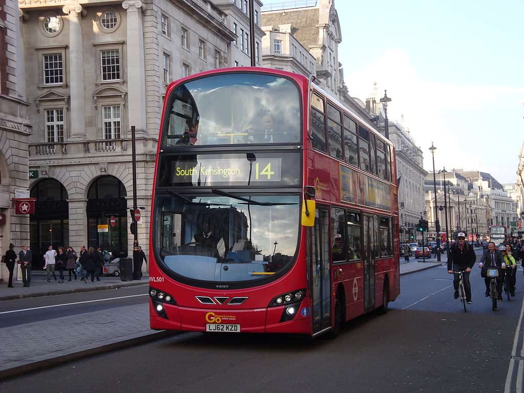 A red London bus headed to South Kensington