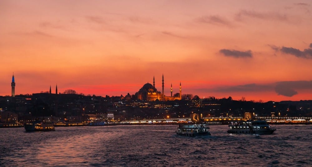 Bosphorus dinner cruise boats on the waters next to Istanbul at sunset. Image source: Pixabay user Bakhrom Tursunov.