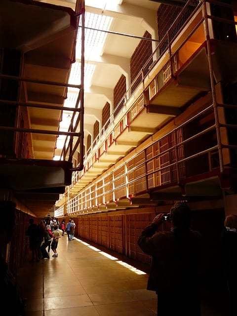 Tourists exploring the jail cells in Alcatraz. Image source: Pixabay user LoggaWiggler.