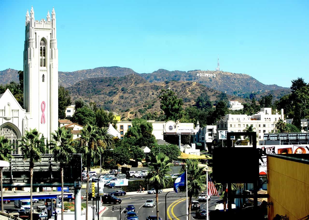 A view of the Hollywood sign with the Hollywood United Methodist Church. Image source: Pixabay user DEZALB.