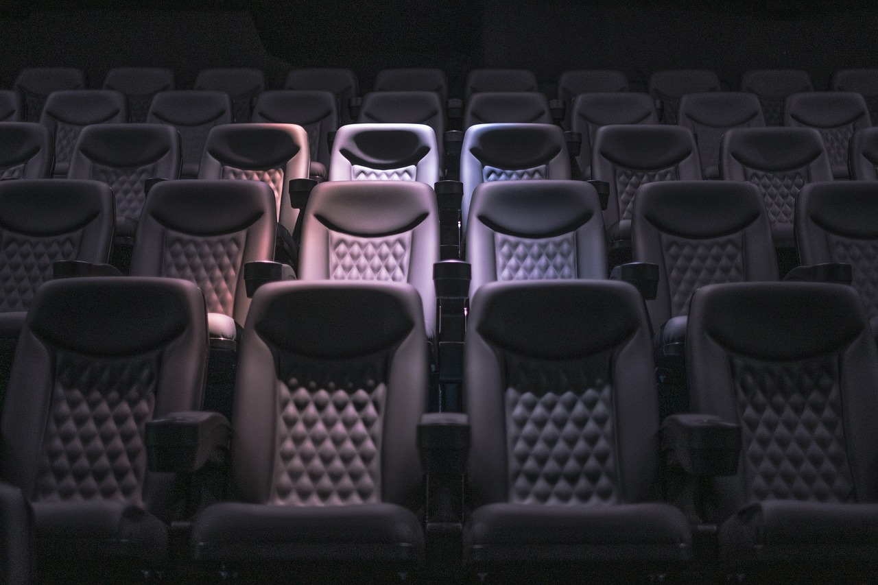 A row of seats in a movie theater. Image source: Pixabay user Tim Pritchard.