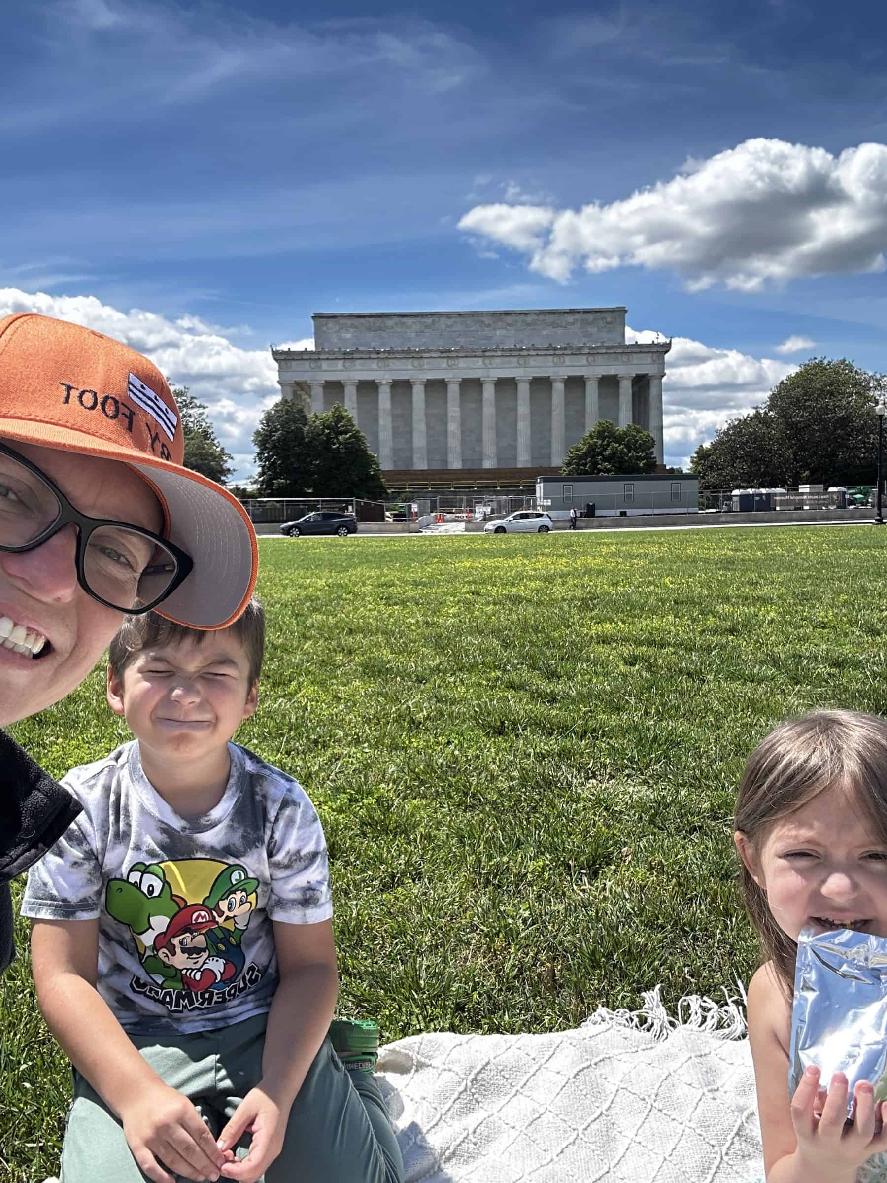 Sitting on the grass south of the Lincoln Memorial.