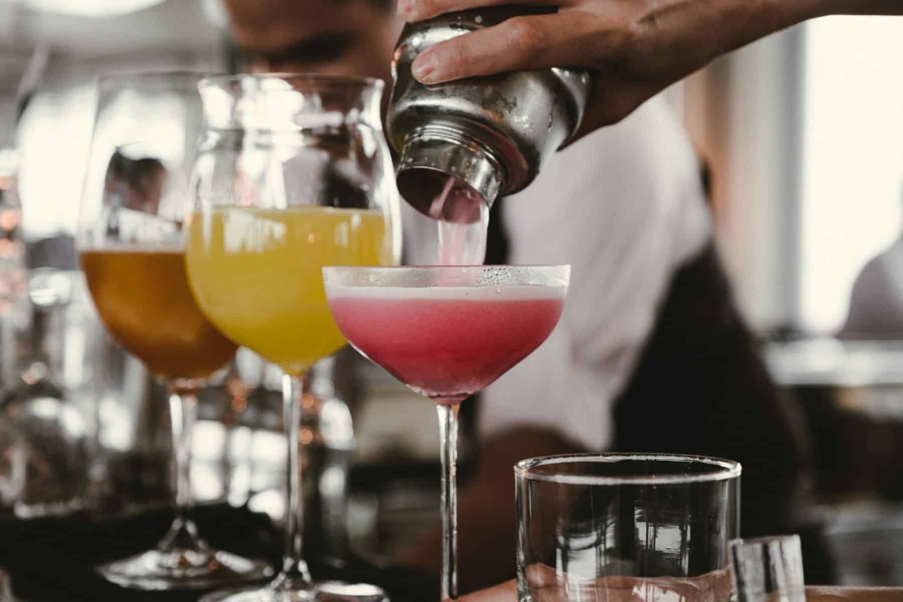 a bartender pouring a drink