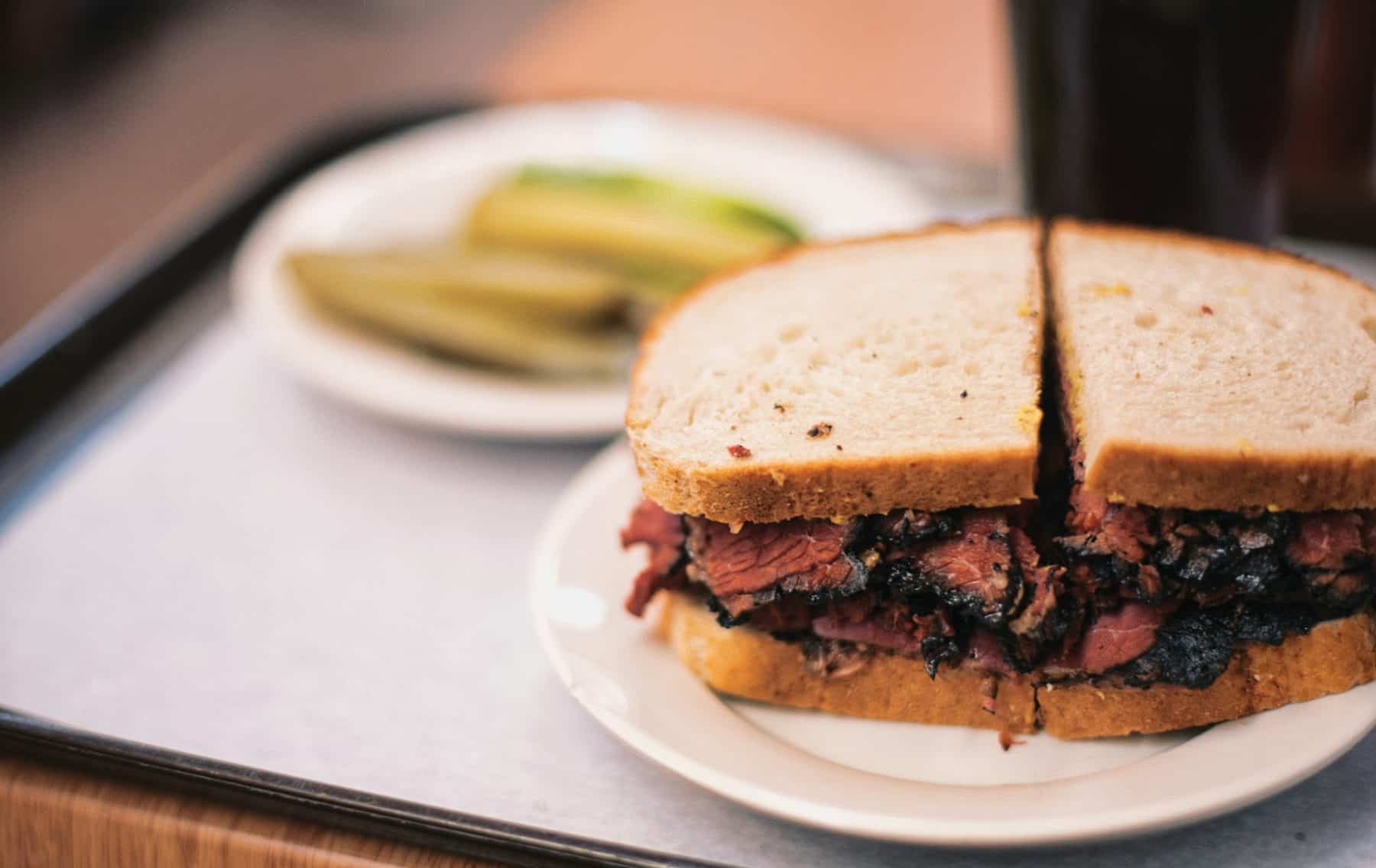 a pastrami sandwich and pickles from Katz Delicatessen
