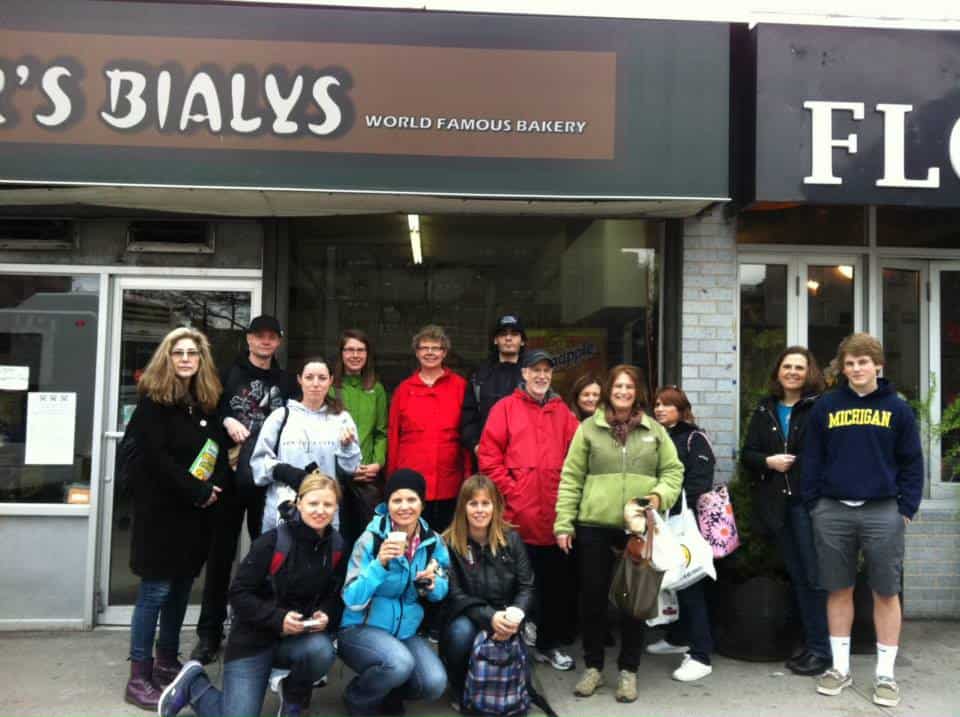a group of tour guests in front of Kossar's Bialys  on the Lower East Side of Manhattan
