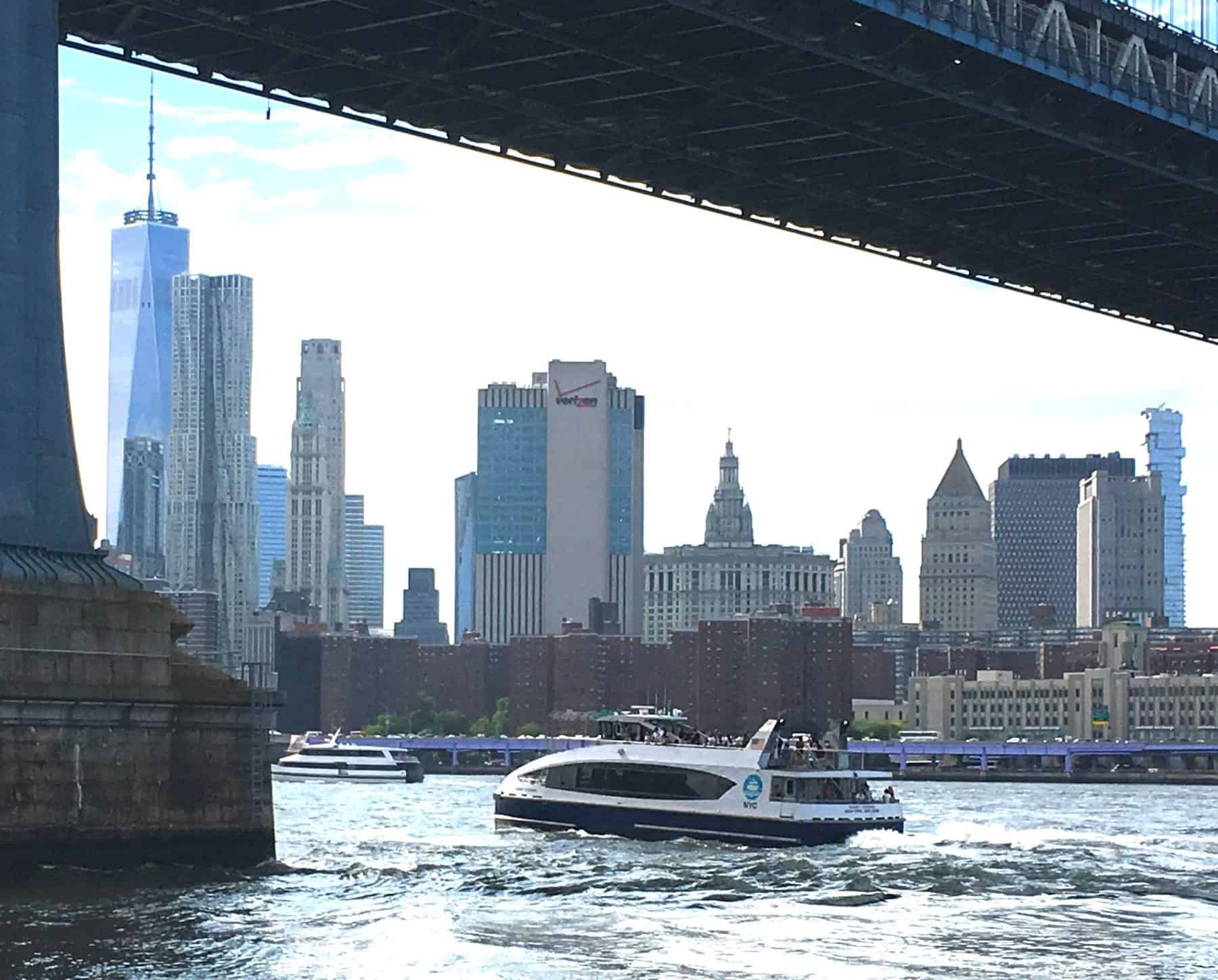 NYC ferry boat under the Manhattan Bridge